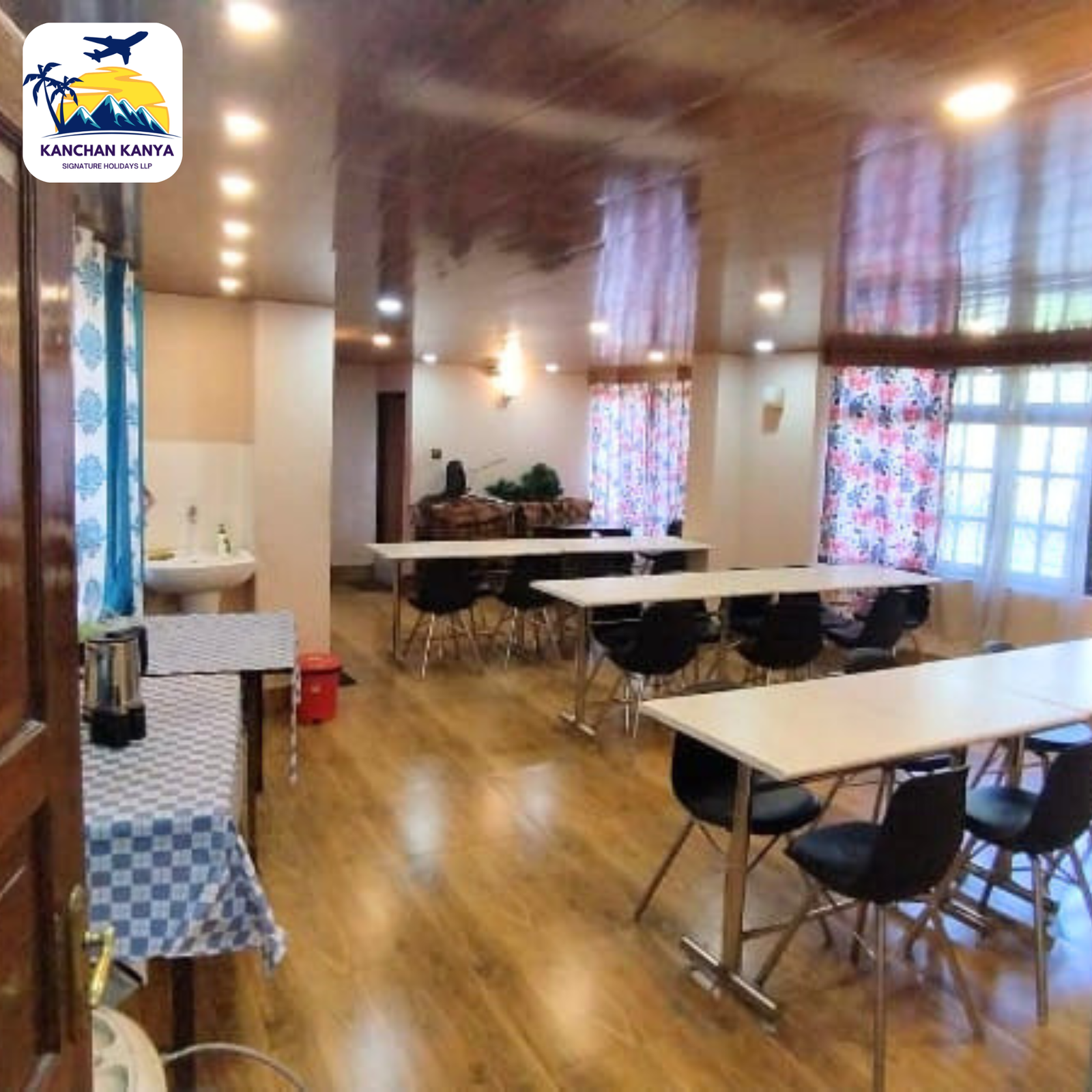 Logo of KANCHAN KANYA in the top-left; dining area with white tables and black chairs in a bright hall.